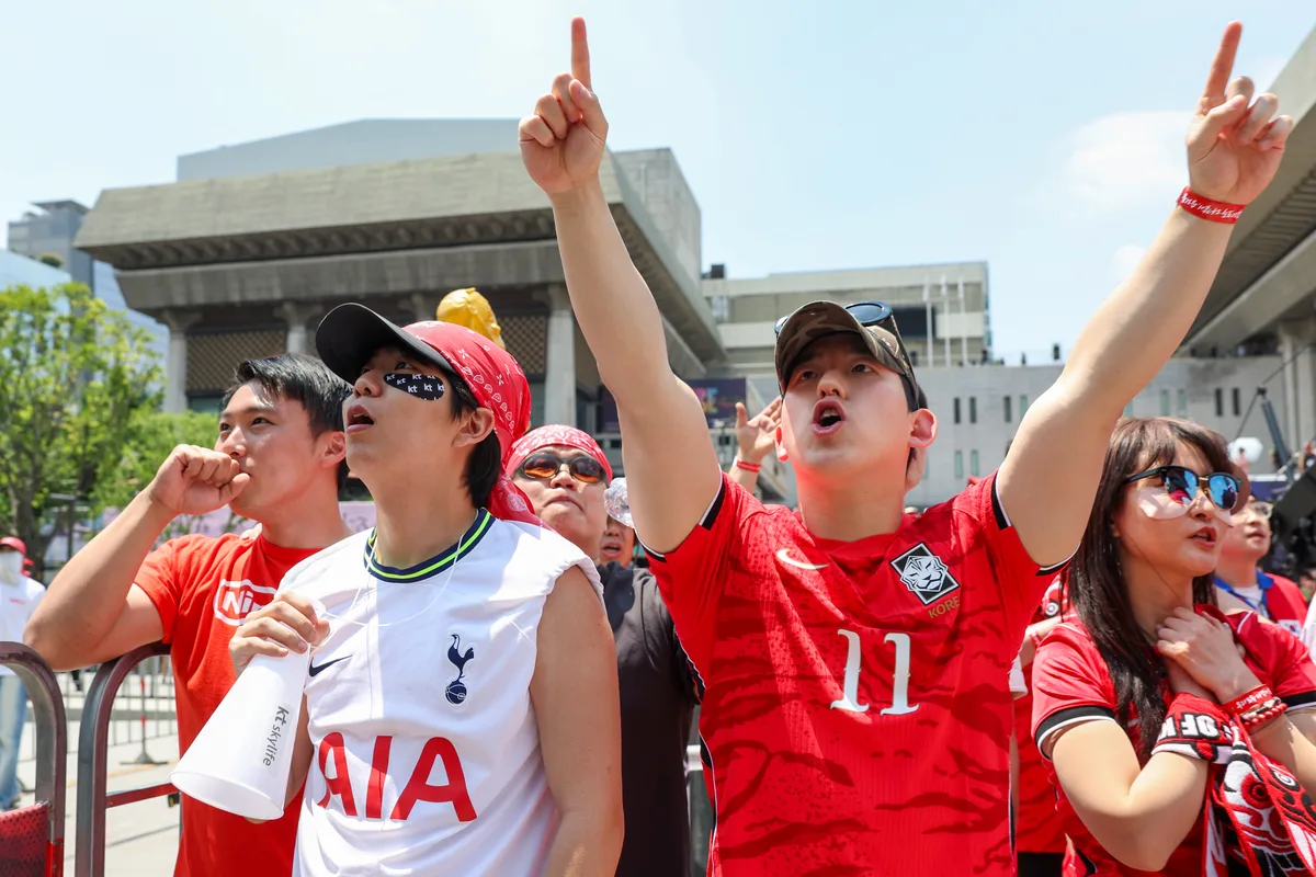 South Korean fans cheering on the national team at Seoul's Gwanghwamun fan zone during the 2026 World Cup